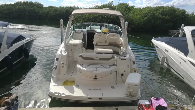 Stern view of the Monterey sport yacht moored among mangroves in Cancun, spacious cockpit seating for Caribbean day trips