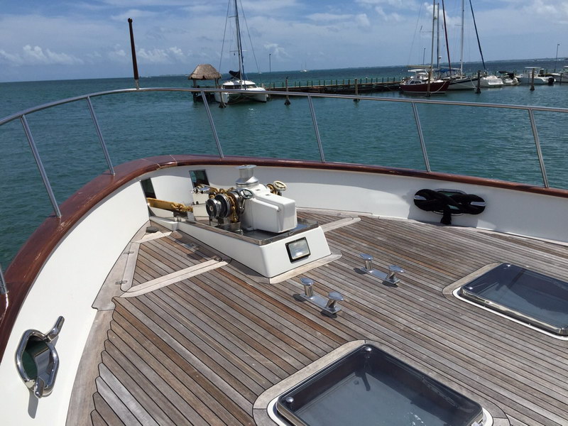 Australis 78 ft charter yacht at sunset on turquoise Caribbean sea, romantic overnight cruise from Cancun