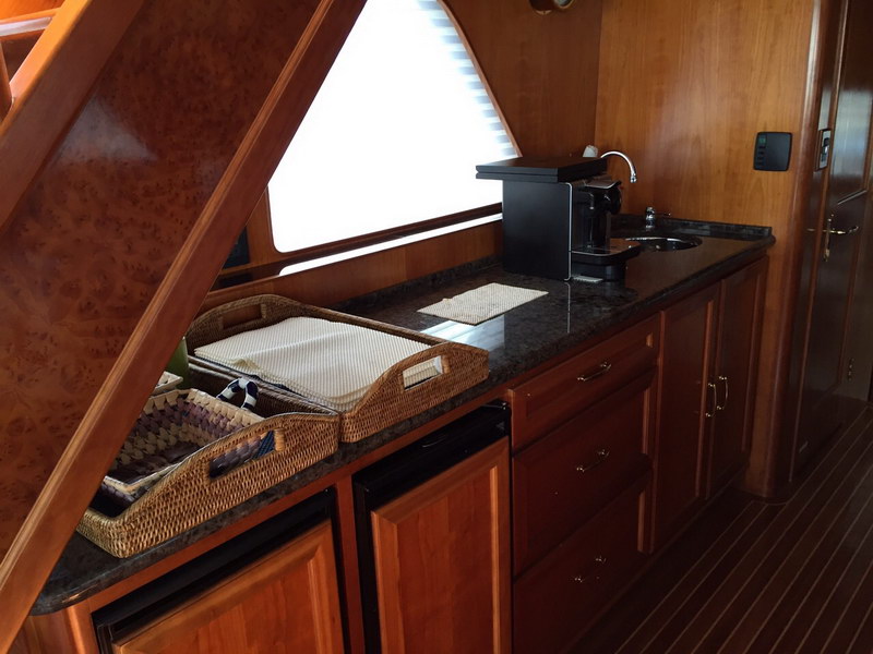 Australis 78 ft yacht approaching turquoise Caribbean anchorage near Cancun Riviera Maya, private island tour