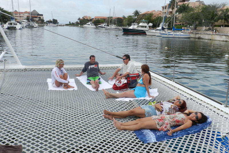 Guests aboard Raiatea 82 ft group catamaran during day tour excursion Puerto Aventuras Riviera Maya Caribbean sailing