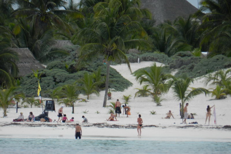 Group tour participants at Tulum archaeological site after sailing from Puerto Aventuras on Raiatea catamaran