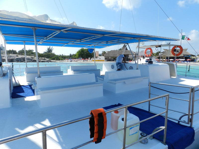 Isla Mujeres with blue canopy shade, bench seating and life rings, 90-person sailing charter Cancun