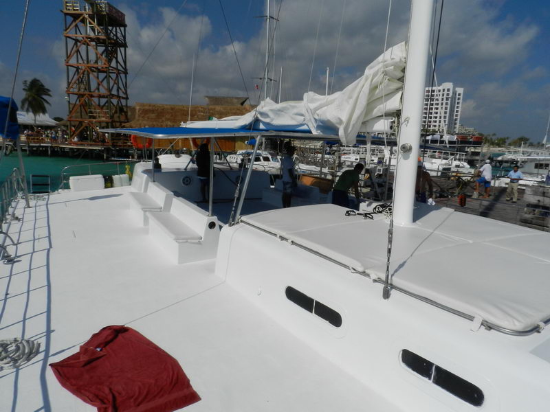 Front deck of Catamaran Samba 3 at Cancun Isla Mujeres marina, spacious white sailing catamaran for private group tours up to 90 people