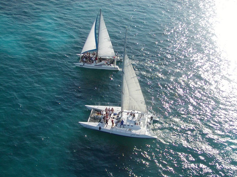 Tiger catamaran at anchor in the turquoise Caribbean Sea near Isla Mujeres on a private group charter from Cancun