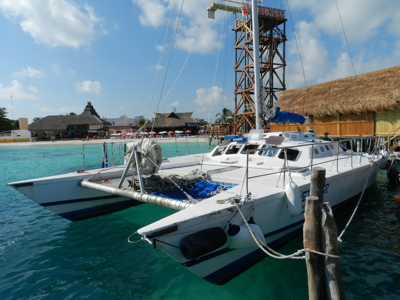 Side view of the Tiger catamaran under sail on a private group excursion in the Caribbean near Cancun and Isla Mujeres